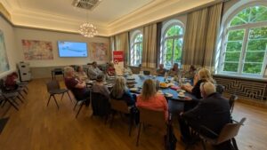 Das Bild zeigt Bürgermeister Eckhard Graf im Gespräch mit Freiwilligen der Nachbarschaftshilfe im Ratssaal des Ratzeburger Rathauses.